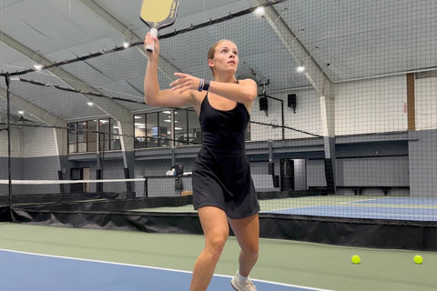 Hannah hitting an overhead with an eastern grip